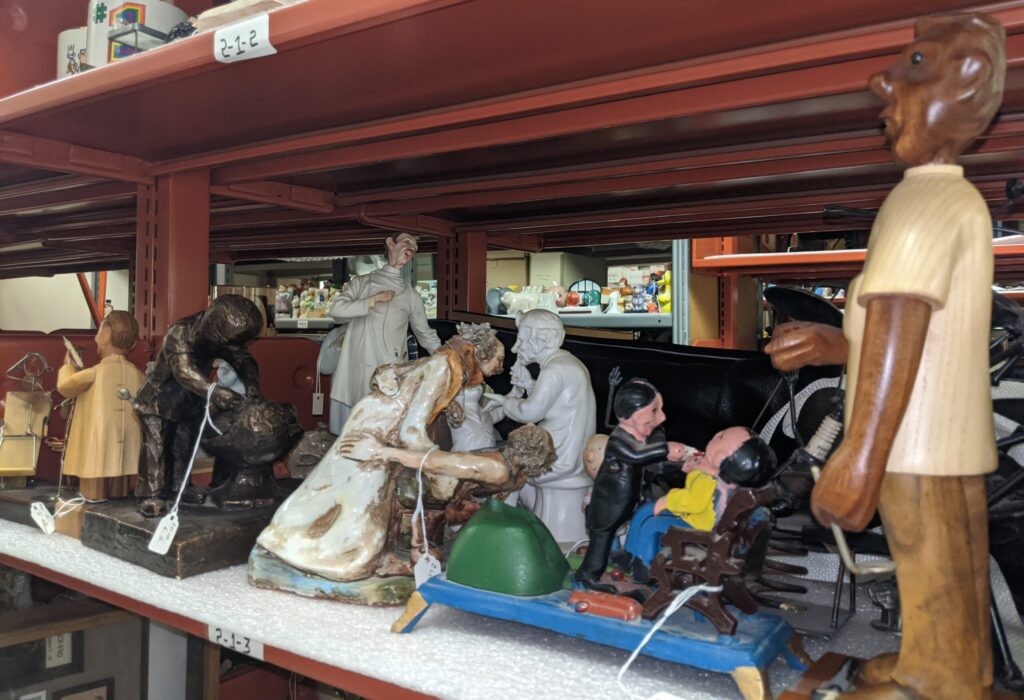 Dentistry-themed figurines on a shelf in the museum's collection room